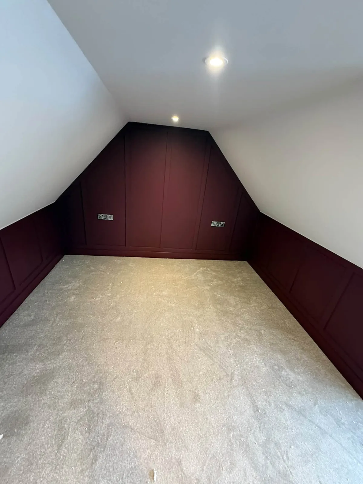 Fitted beige carpet in a loft bedroom